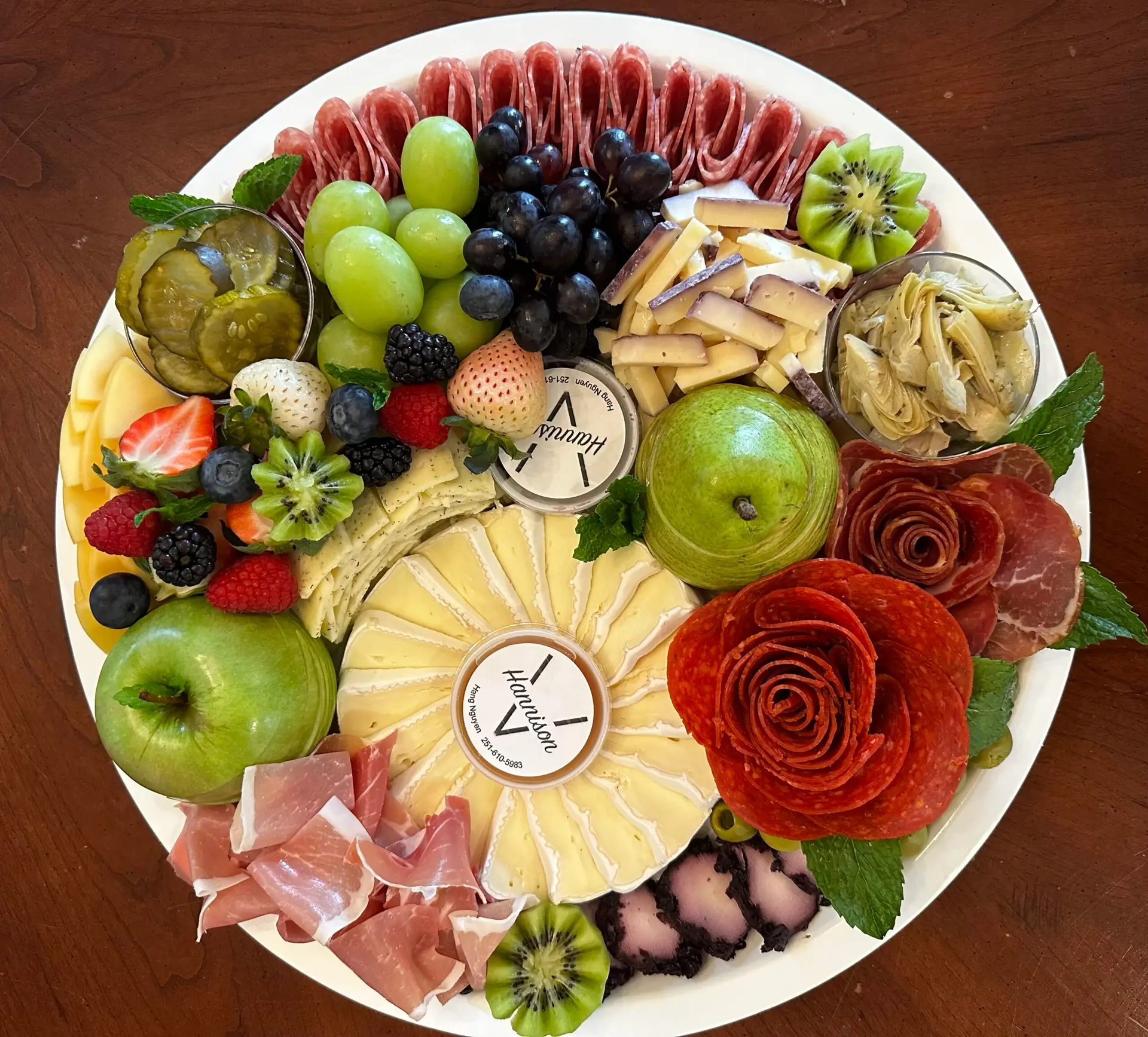 photo of red themed charcuterie board, with rose for color